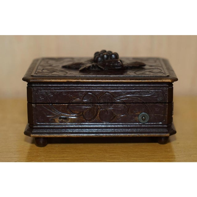 This antique original circa 1880 Black Forest Wood music box with grape vine carving to the top A very good looking and...