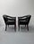 A sophisticated pair of vintage barrel-back tub armchairs dating to the 1970s, featuring gracefully curved backs, button-...
