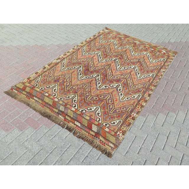 This beautiful, traditional vintage, flatweaved Turkish kilim rug is approximately 60 years old. It is handmade of very...