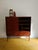 This elegant danish teak highboard from the 1960s is a versatile piece that exemplifies the functional beauty of mid-...