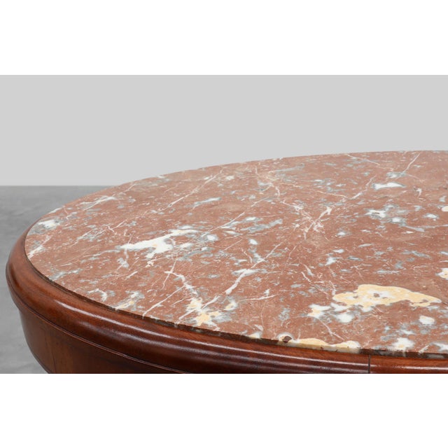 An elegant Belgian Art Deco side table attributed to De Coene, dating from around 1925. The piece features a richly...
