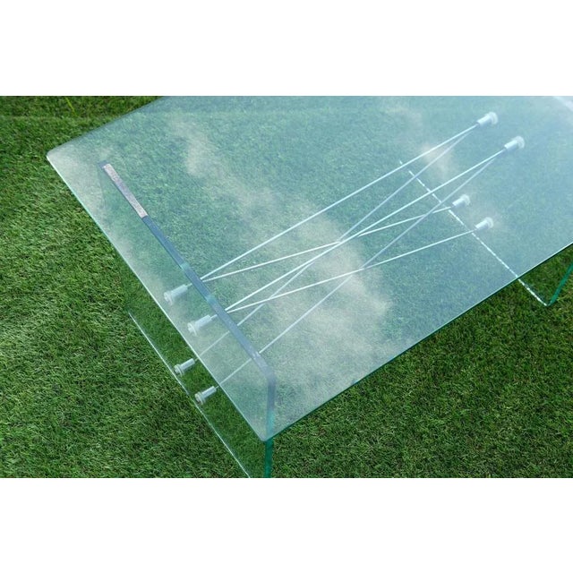 Glass coffee table / living room table with steel cable frame in the style of FontanaArte, Italy. In excellent condition....