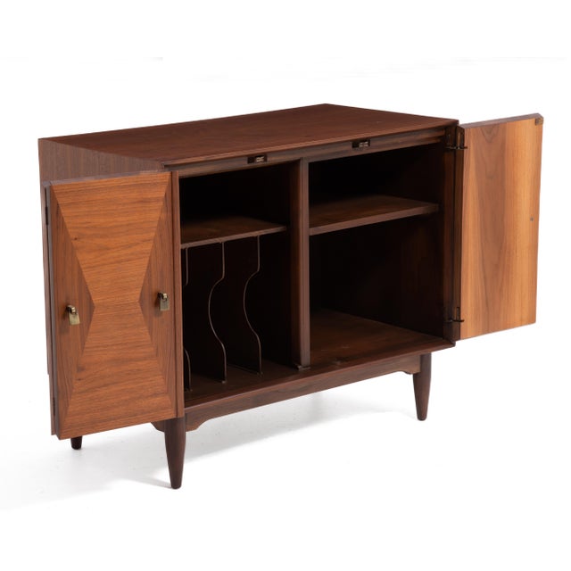 An unmarked Mid Century diamond front cabinet by Ramseur Furniture of Ramseur, North Carolina. Walnut with brass handles....