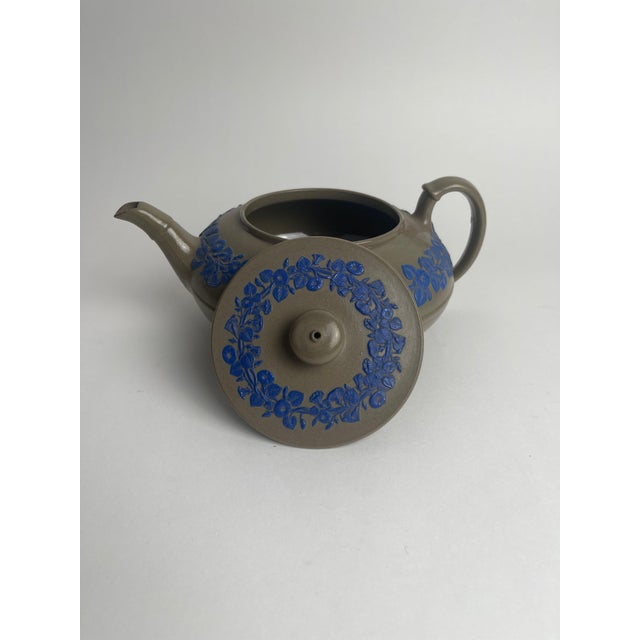 This Wedgwood drabware stoneware teapot, dating to around 1830, is a beautifully refined example of the company's mastery...
