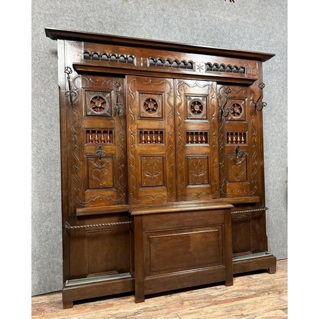 Large coat rack with built-in storage chest, made of solid oak around 1880 from a Norman box bed. Decorated with carvings...