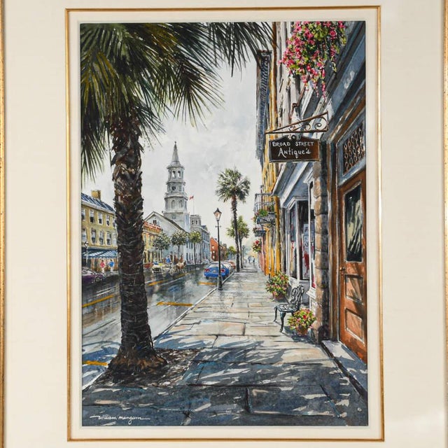 A Framed Print of William Mangum's "Broad St Antiques" depicts a detailed, atmospheric street scene featuring an antique...