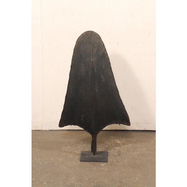 A Naga rain shield, on custom iron stand, from the Northeastern part of India's border with Myanmar (Burma), from the mid...
