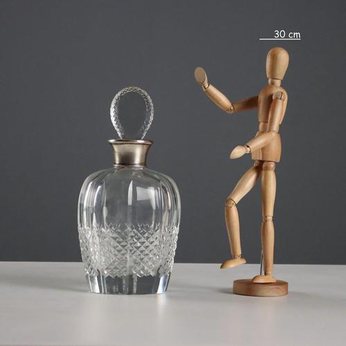 Ground and ashlar glass bottle with a silver ring. Engraved silver hallmarks. This piece is attributed to the mentioned...