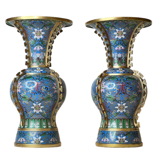 Pair Chinese cloisonne enamel vases with floral designs on blue ground and gilt mounts representing stylized dorsal fins...
