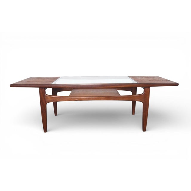 Origin: England Designer: Victor B. Wilkins Era: 1966 Materials: Teak, Afromosia, Glass Measurements: 54″ wide x 20″ deep...