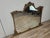 An impressive vintage mirror dating back to the 1960s, featuring a richly carved and lacquered wood frame with an antique...