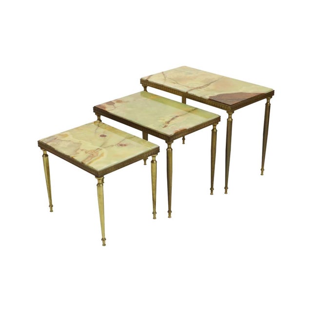 Mid-century set of three nesting tables featuring onyx marble tops and a copper-plated metal frame, in the style of maison...