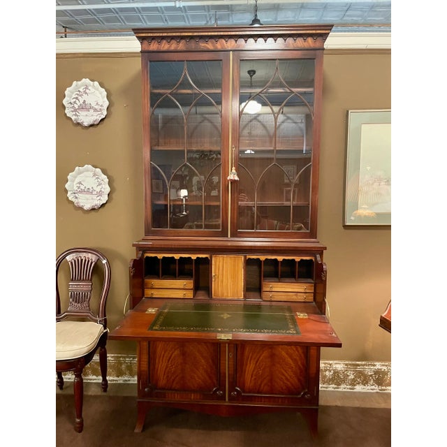 Secretary bookcase of mahogany with satinwood detailed interior; with green tooled leather writing surface on drop down...
