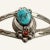 This is part of Chairish’s Fine Jewelry assortment. This Navajo bracelet features a central element of a turquoise nugget...