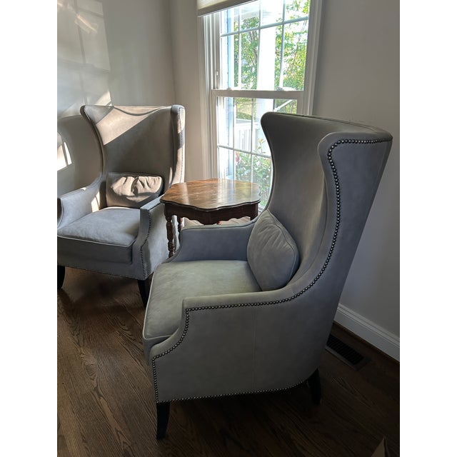 Two Bernhardt lounge chairs featuring beautiful gray leather with a high back and winged sides for extra comfort. The...