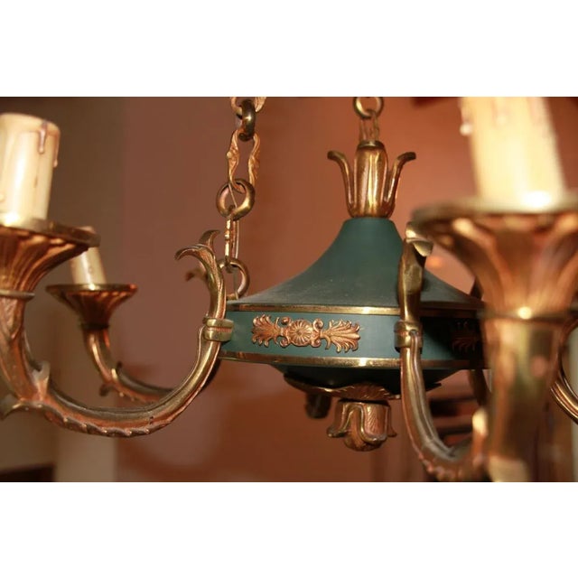 Empire style chandelier in gilt bronze and empire green lacquer 6 lights perfect working condition. This piece is...