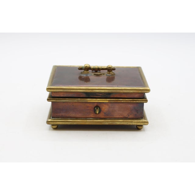 Circa 1800-1820 copper & brass jewelry casket box, English. Raised on ball feet. Once fabric lined. 4.5" w., 3.5" d., 2.5" h.