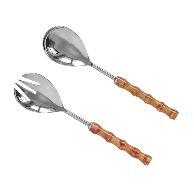 Crafted with gleaming stainless steel and bamboo-inspired handles, this set of two serving spoons blends durability with...