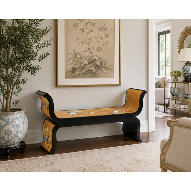 A striking Hollywood Regency style bench finished in black lacquer with hand-painted chinoiserie decoration over luminous...