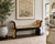 A striking Hollywood Regency style bench finished in black lacquer with hand-painted chinoiserie decoration over luminous...