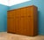 1960s teak triple door wardrobe by Elliots of Newbury, featuring clean lines, a gently curved top rail and integrated...
