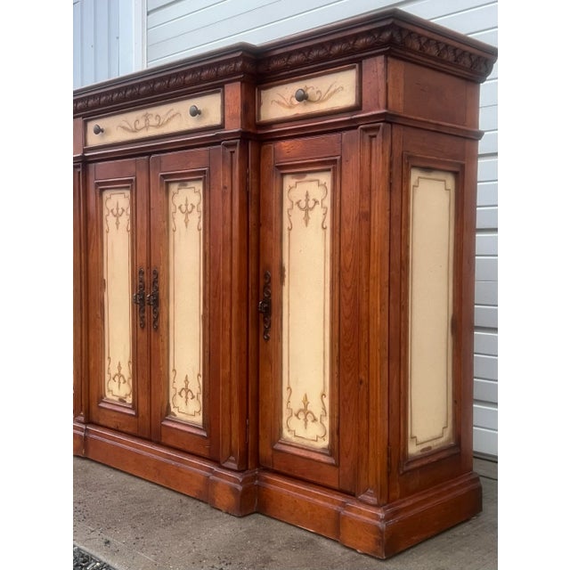 Impressive tall rustic European style sideboard credenza by Hooker Furniture. Wide center drawer over a double door...