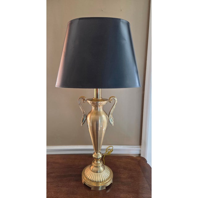 This striking statement piece features a heavy, solid brass urn-style trophy body mounted on a robust tiered base. With...