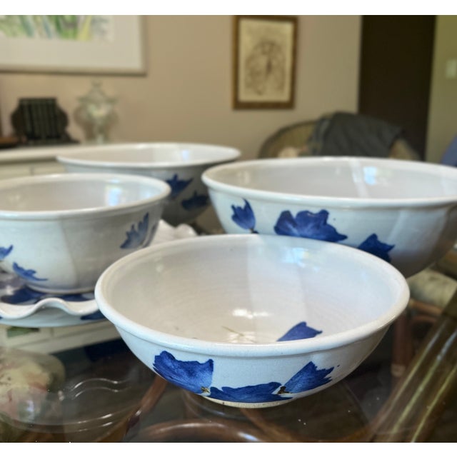A beautiful set of 4 blue on white studio pottery bowls with platter decorated with leaf motifs from the 1980s. The bowls...