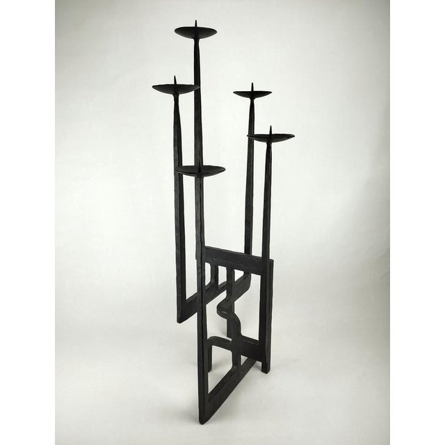 An impressive, sculptural floor candlestick in the brutalist style of its time. It is made of hand-forged, blackened iron...