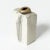Small stoneware sculpture by Bengt Berglund in a boxy form with a striped decor and a gold glazed “mouth” on top. This...