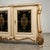 A centerpiece of décor, this imposing sideboard in cream lacquered wood with gold highlights is a magnificent testament to...