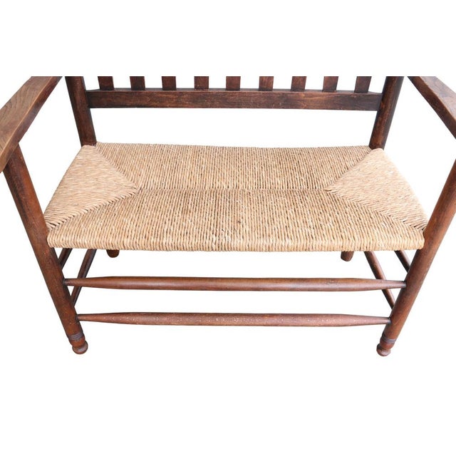 A characterful early 20th-century Dutch wooden bench, executed in a restrained Arts and Crafts style. This beautifully...
