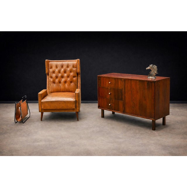 The sideboard is crafted entirely from Brazilian Rosewood, known as Jacaranda, featuring three drawers adorned with brass...
