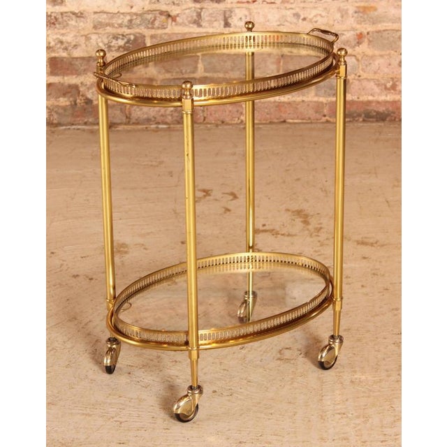 French Mid Century Maison Jansen style brass and glass bar cart / serving trolley, circa 1950s. Excellent condition. W...