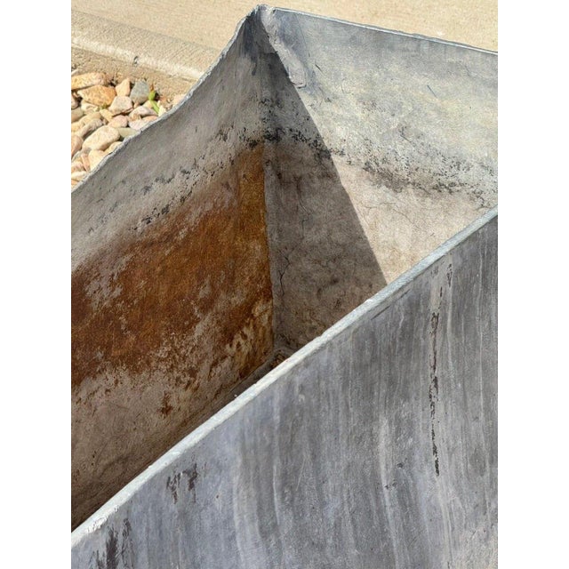 A pair of substantial zinc planters, designed to be connected at the ends for a seamless look. These heavy-duty planters...