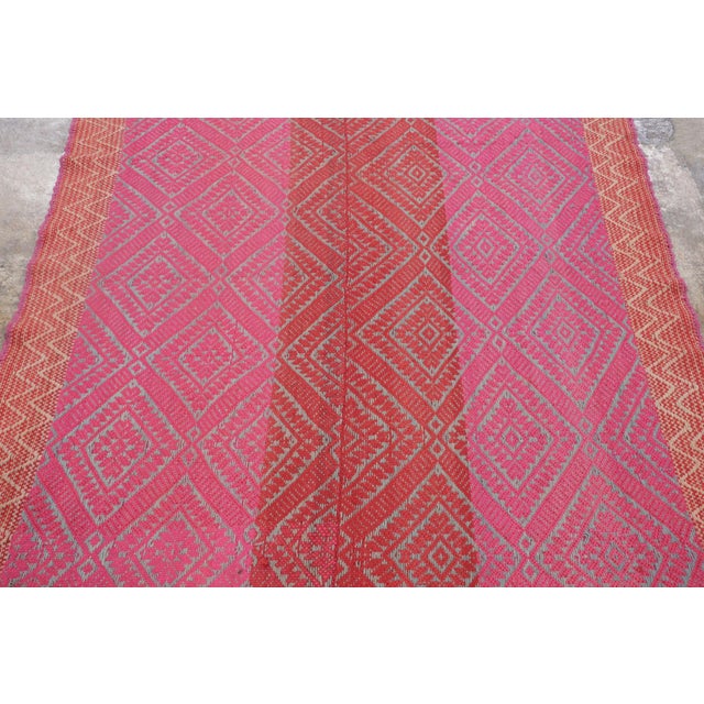 Hand-woven in wool circa 1950–1960, this 5x6 vintage Peruvian Kilim, traditionally known as a Frazada, is a vibrant...