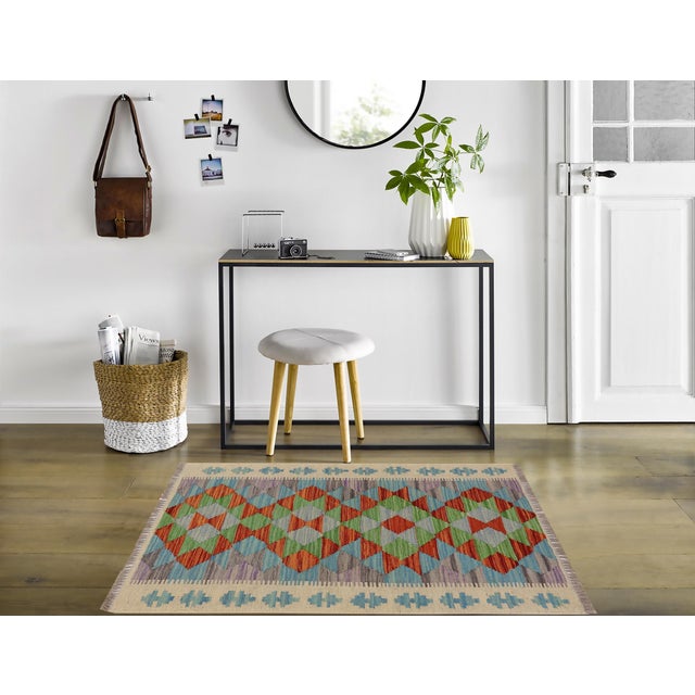 Elevate the elegance of your home with this stunning hand-woven tribal Kilim wool rug. Meticulously crafted on a loom by...