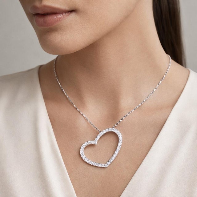 Beautiful 14K white gold diamond heart necklace set with approximately 1.95 Carat Total Weight diamonds, forming a radiant...