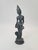 A figurine depicting a South Asian temple dancer / a figure inspired by Buddhist and Khmer art, made of patinated...