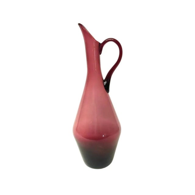 we have for your consideration a very beautiful mid century modern glass pitcher manufactured by empoli made in Italy....