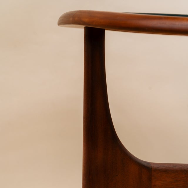 This Italian Mid-Century/Organic Modernist style coffee table features a tripod base sculpted from solid teak in a warm...