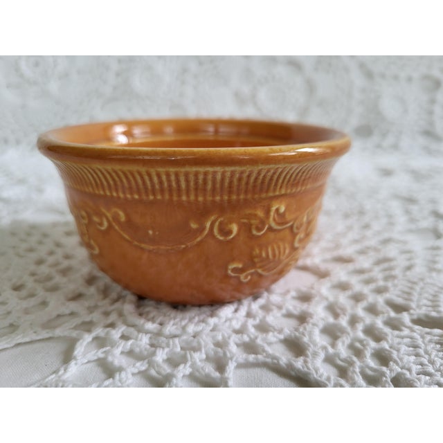 An orange oven safe ramekin, marked 'Made in USA'. It measures 3 3/4" diameter x 2" h x 2 1/4" base. This would make a...