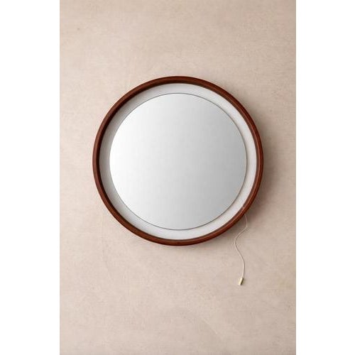 This round mirror from the 1960s demonstrates the subtlety of design. The combination of warm teak veneer, a slender...
