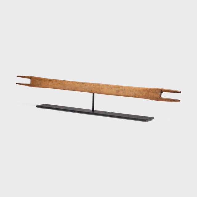 This long, wooden carving is an early 20th century Chinese weaving shuttle, once used by skilled artists in Yunnan...