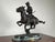 This dynamic bronze sculpture after Frederick Remington’s celebrated Trooper of the Plains captures the drama and movement...