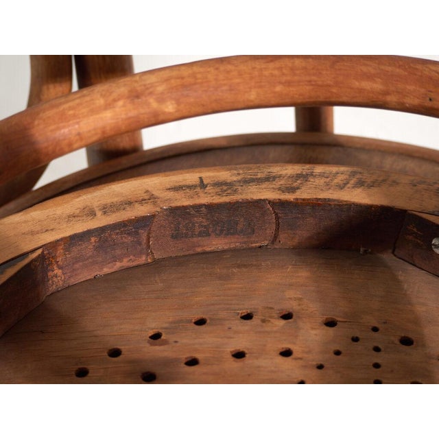 A set of two antique chairs in bentwood, with a closed hoop back with an inner loop and a moulded board seat. Originates...