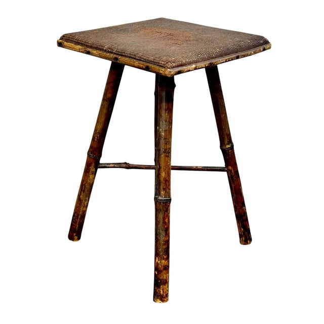 A delightful and unusual late 19th century English bamboo stand, featuring a handwoven raffia top and classic bamboo...