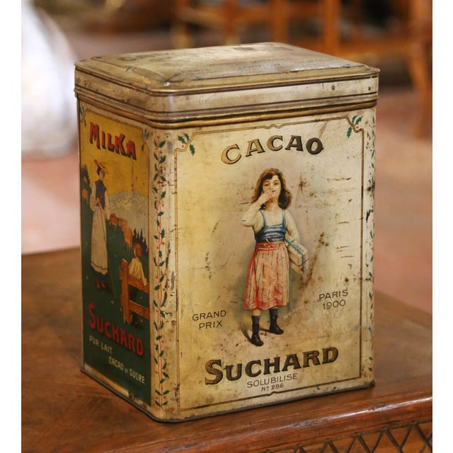 This colorful antique advertising tin was created for the celebrated Swiss chocolate manufacturer Suchard during the early...