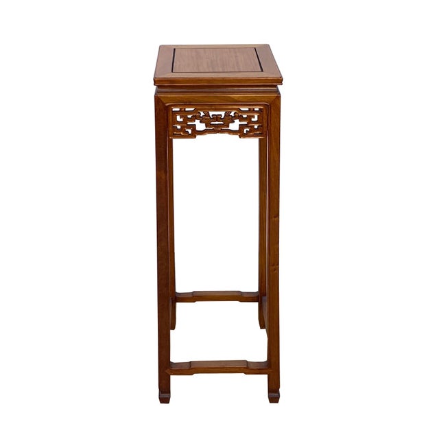 This is a simple square shape oriental accent plant stand, pedestal table stained in brown color. The Oriental pattern is...