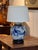 A blue and white Chinese ginger jar mounted as a lamp, painted with figures gathered in a garden beneath flowering...